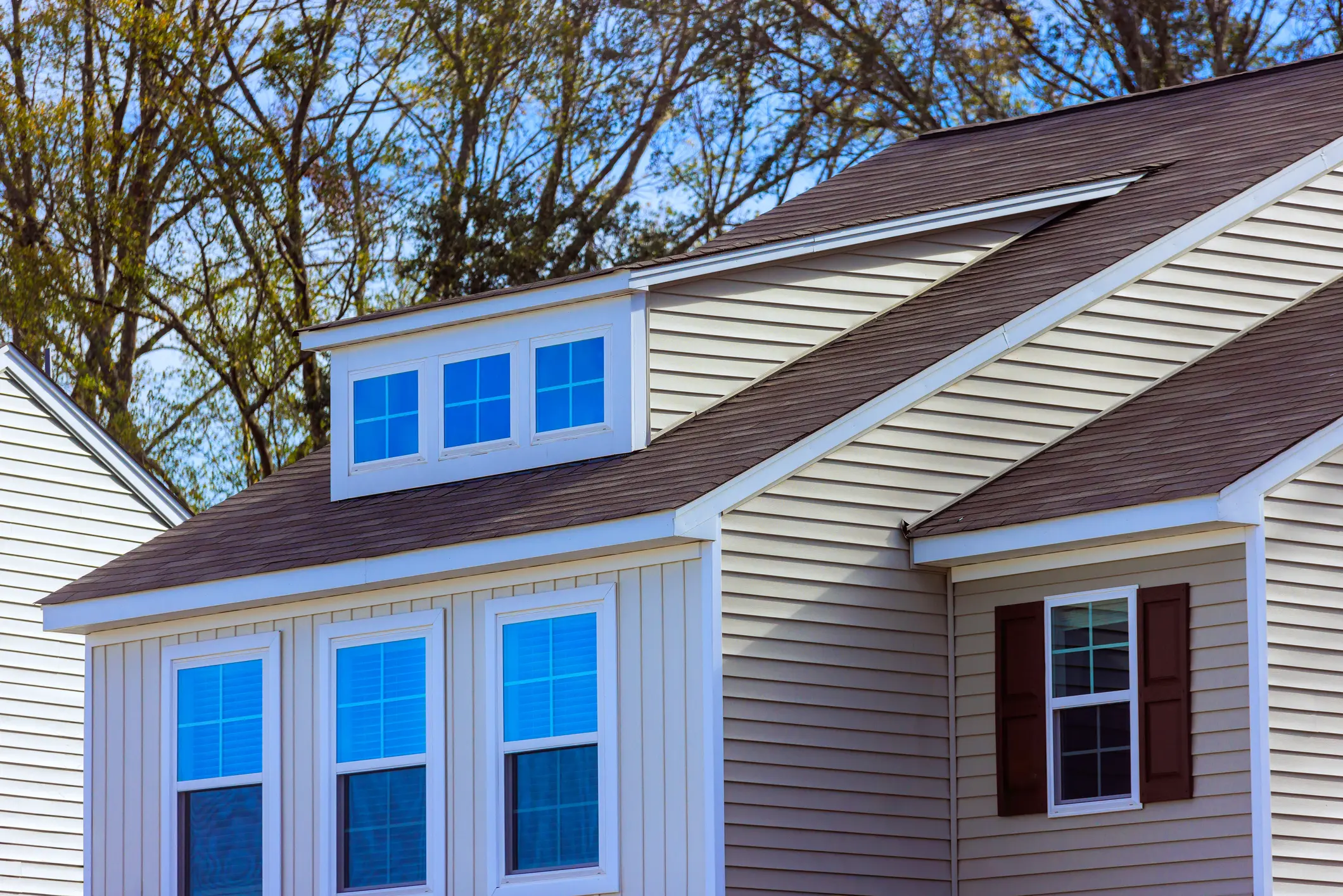 Beige siding house under blue sky