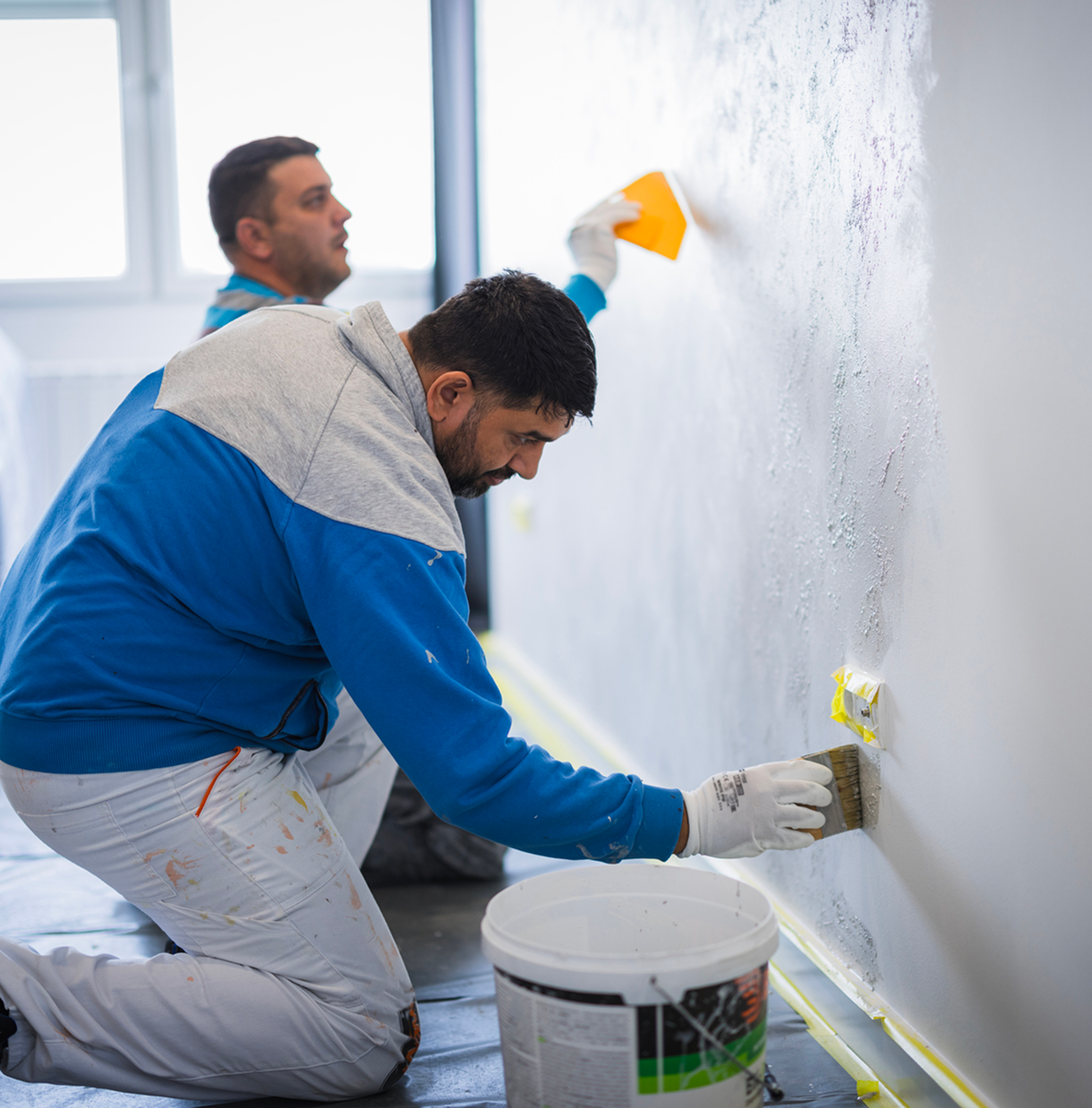 Painters applying texture to a wall