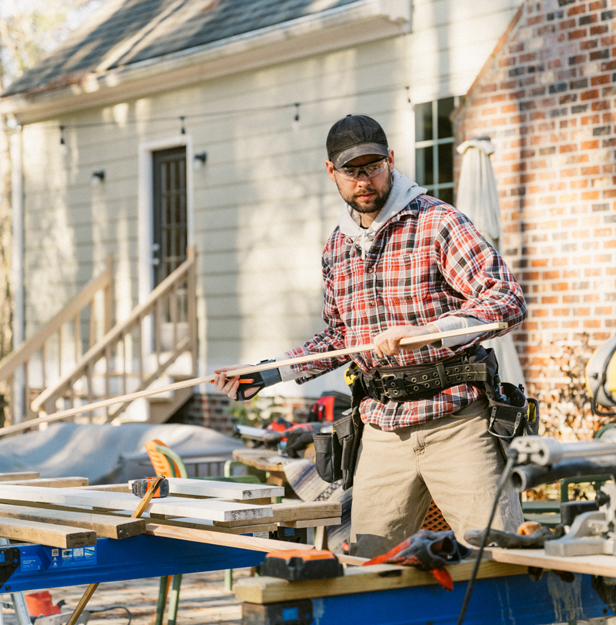 Craftsman in plaid shirt with tools