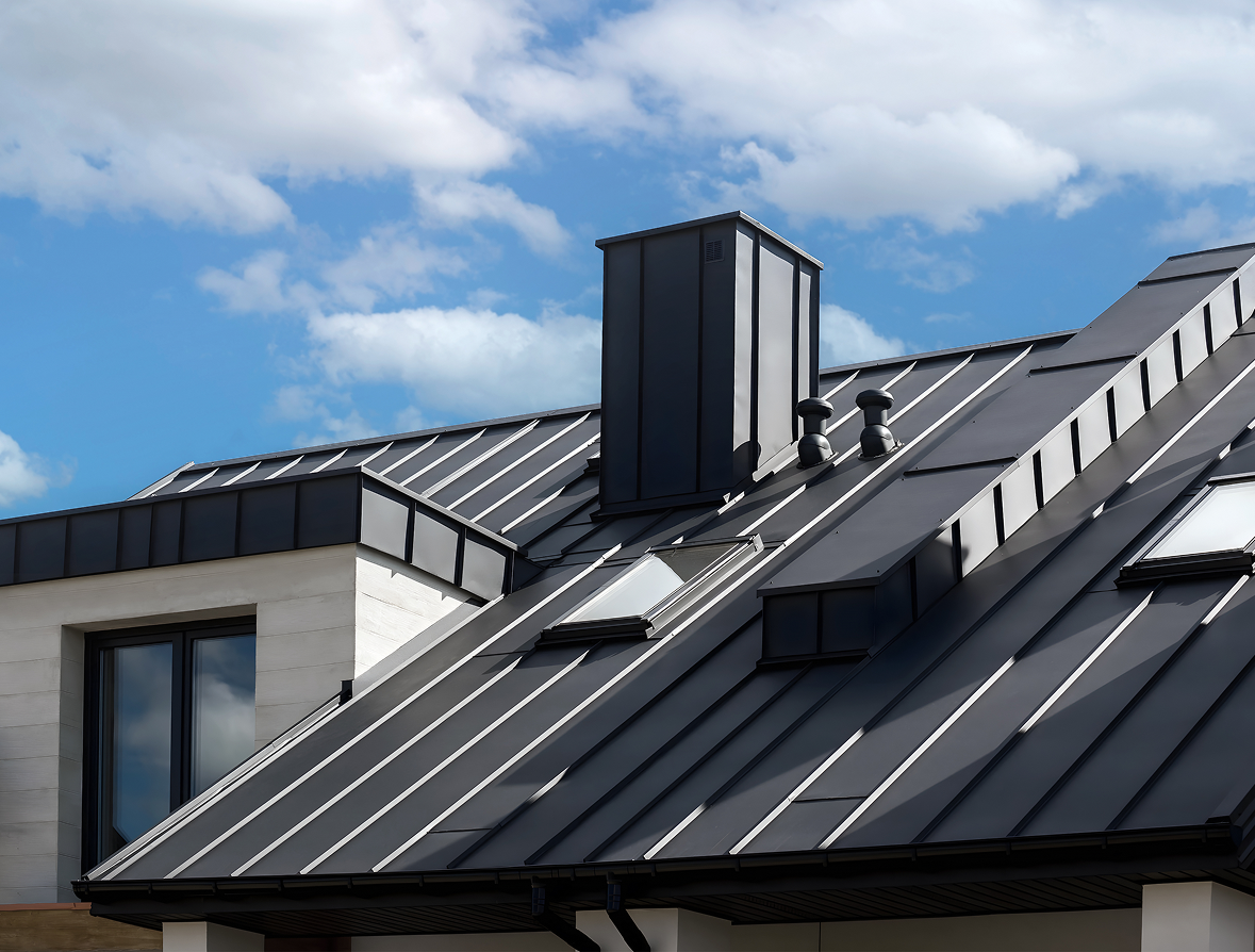 Black metal roof with chimney and skylights